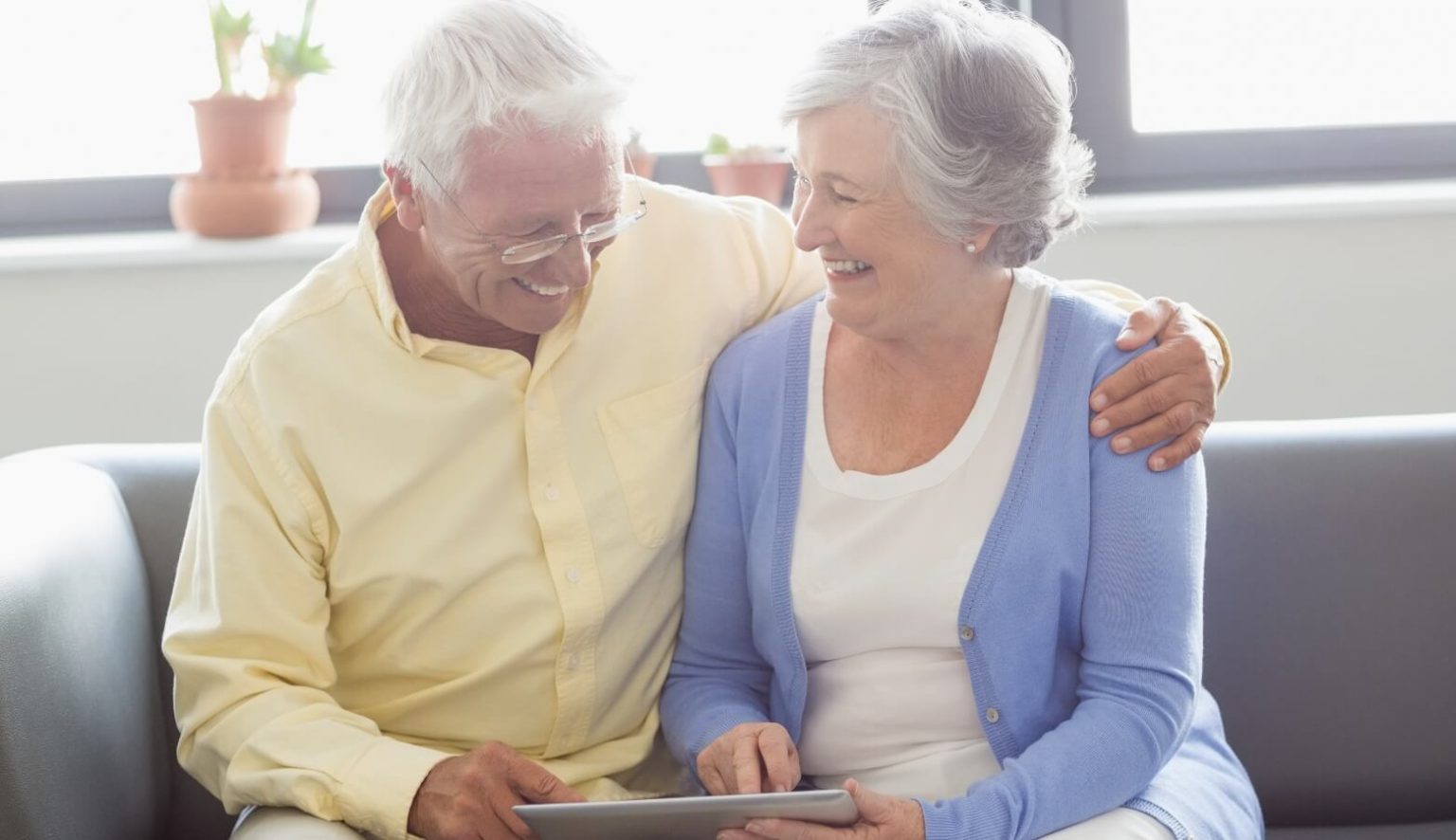 senior couple using a tablet